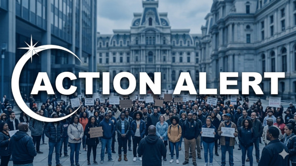 Crowd of diverse protesters in a city square holding signs, with a bold 'ACTION ALERT' overlay across the image and a historic building in the background.